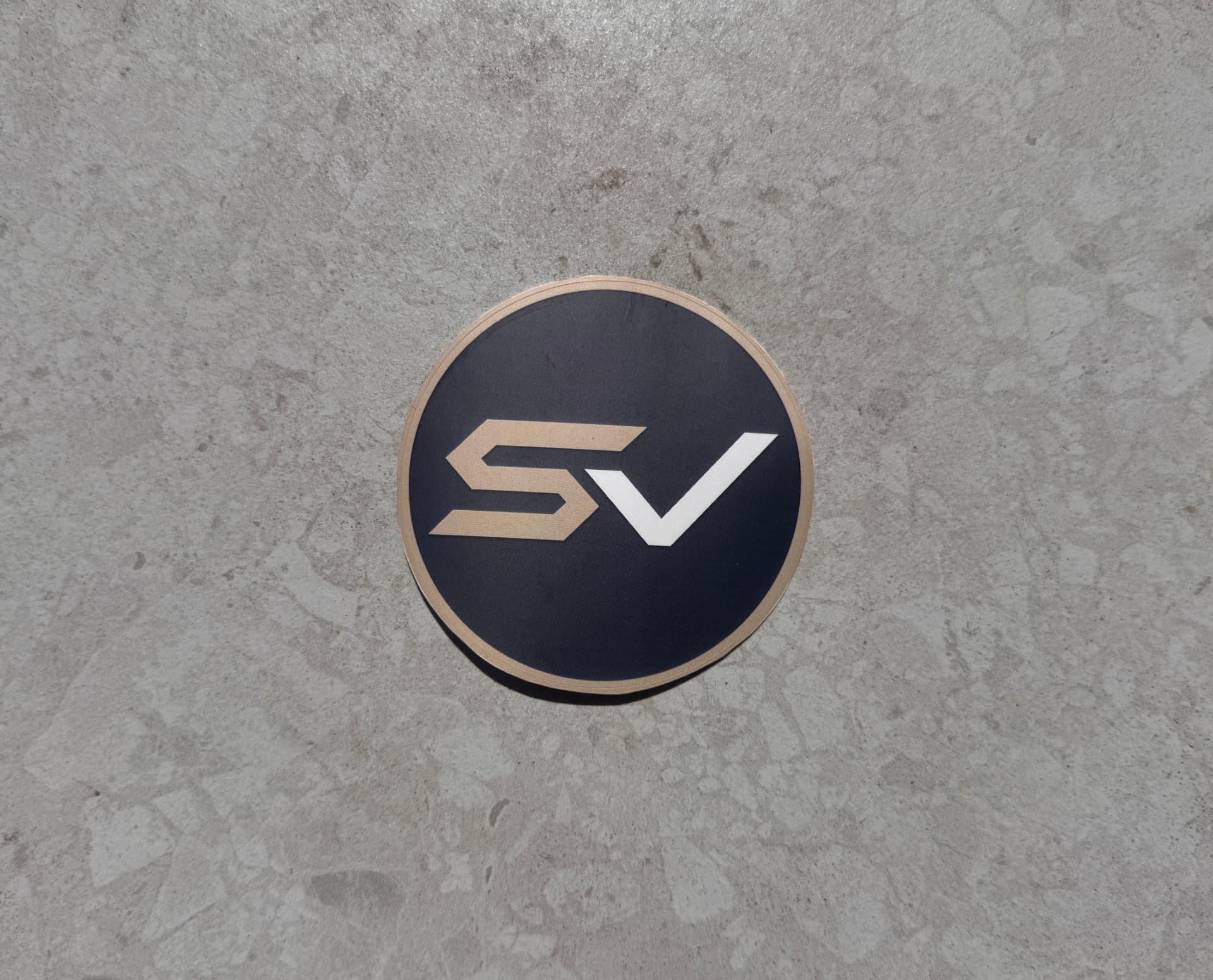 SaltVector SV round sticker photographed on concrete
